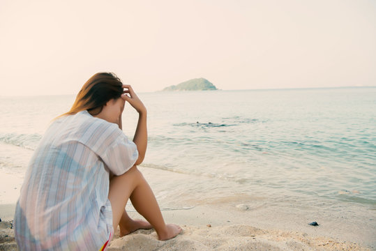 young woman on the beach and be sad concept