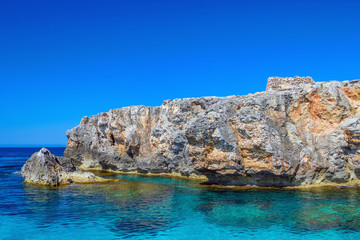 South coast cliff of Menorca island with small ancient talayot.