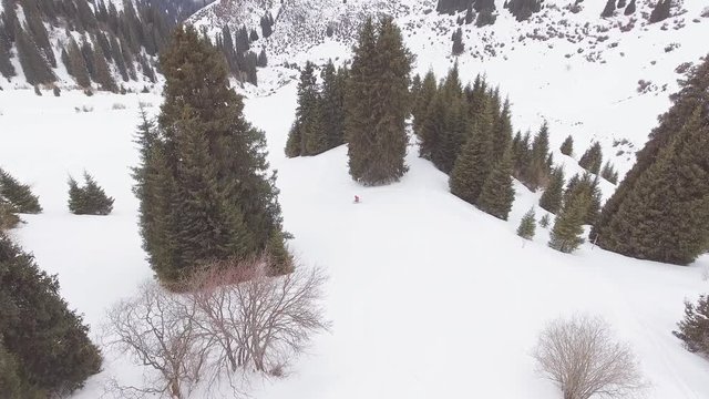 Aerial view footage skier riding by powder at mountain backcountry
