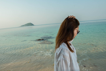 young woman on the beach and be sad concept