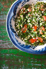 Tabouli middle eastern salad at glass bowl over floral napkin