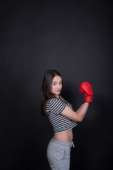 Pretty young sport woman with boxing gloves