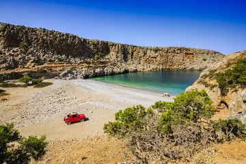 Happy traveler family sitting on the beach under umbrella. Amazing bay with turquoise water 4x4...