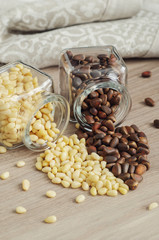 Walnuts in glass bonbonniere, linen napkin on wooden table