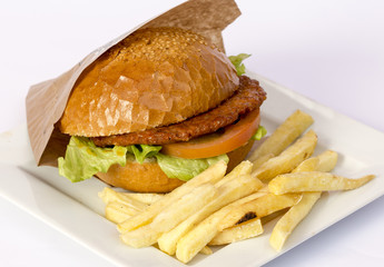 Cheeseburger and fries on restaurant table