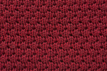 Red knitted wool fabric texture background