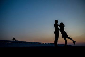 Silhouette couples in love the sky.