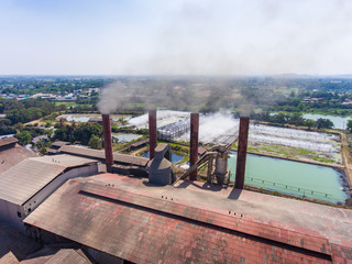 Aerial shot of sugar factory and smoking chimneys. Industrial landscape.
