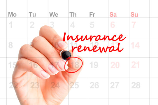 Insurance renewal reminder in calendar handwritten  by woman hand