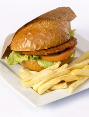 Cheeseburger and fries on restaurant table