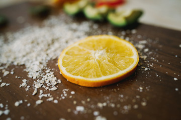 Fresh avocado, orange on the desk. Healthy eating.