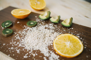 Fresh kiwi, avocado, orange on the desk. Healthy eating.