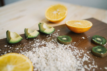 Fresh kiwi, avocado, orange on the desk. Healthy eating.