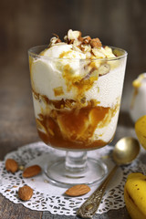Portion of ice cream dessert with banana and homemade caramel.
