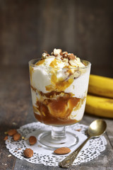 Portion of ice cream dessert with banana and homemade caramel.