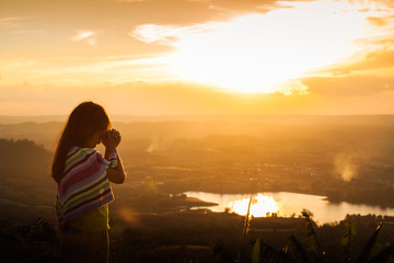 Child praying on the mountain, thank God. © beerphotographer