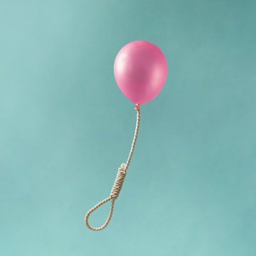 Pink balloon with hangmans noose on blue background. Emotional concept.