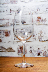 Empty wine glass against a rustic background