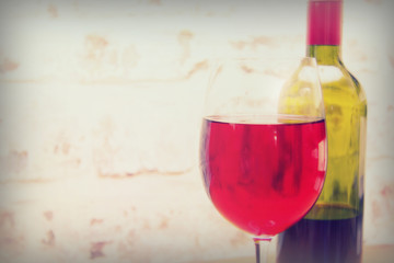 Bottle of red wine with glass ready to pour