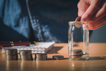 Saving money concept Man hand putting Row and coin stack growing business