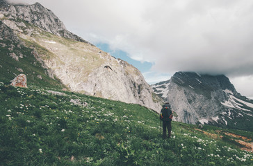 Man Traveler with backpack hiking in mountains Travel Lifestyle success concept adventure summer...