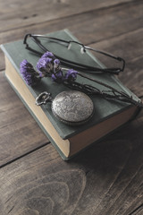 Antique pocket watch, glasses and book