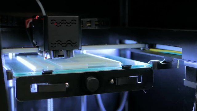 Three dimensional printer during work. 3D printing. Exhibition of modern technologies. Future and technology concept