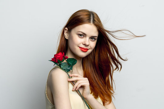 happy woman with red lips and rose on shoulder