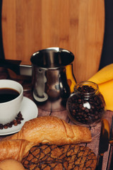 bucket and cup with a drink, croissant and oatmeal cookies