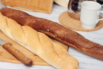 baguette on the table and crumb with a ladle