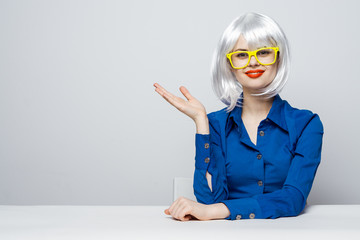 blonde in glasses gesticulates with her hands