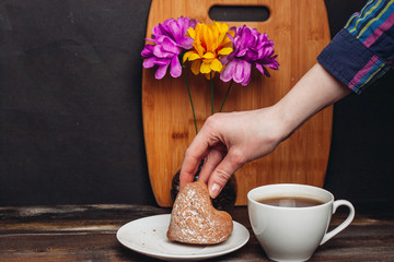cup with a drink and a cupcake in a plate, colorful flowers