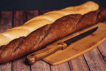 two baguettes and a knife on the blackboard