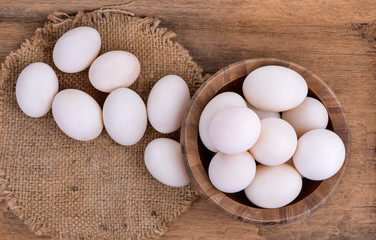 eggs in cup on wood background