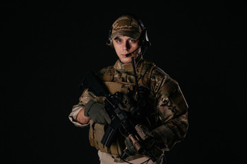 Portrait soldier or private military contractor holding sniper rifle. war, army, weapon, technology and people concept. Image on a black background.