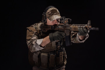 Portrait soldier or private military contractor holding sniper rifle. war, army, weapon, technology...