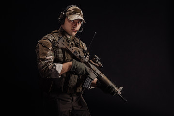 Portrait soldier or private military contractor holding sniper rifle. war, army, weapon, technology...