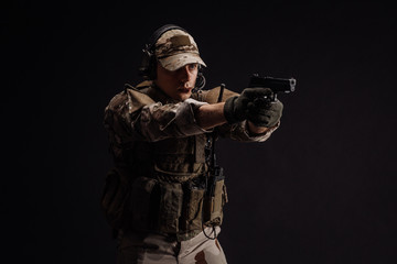 Portrait soldier or private military contractor holding sniper rifle. war, army, weapon, technology and people concept. Image on a black background.