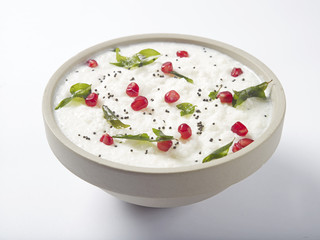 Curd rice in a bowl topped with pomegranate 