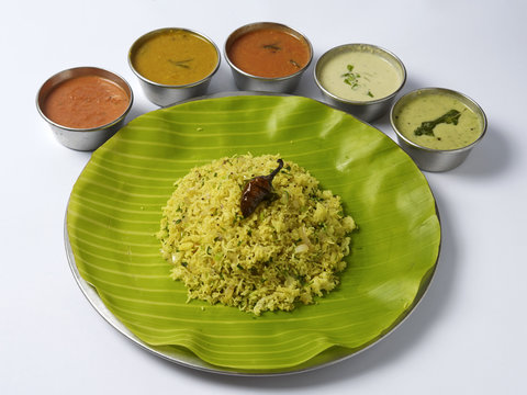 Onion lemon sevai served in a plate with sambar and chutney on white background