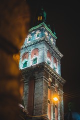 Fototapeta premium Neo Gothic style cathedral tower in night Lviv city