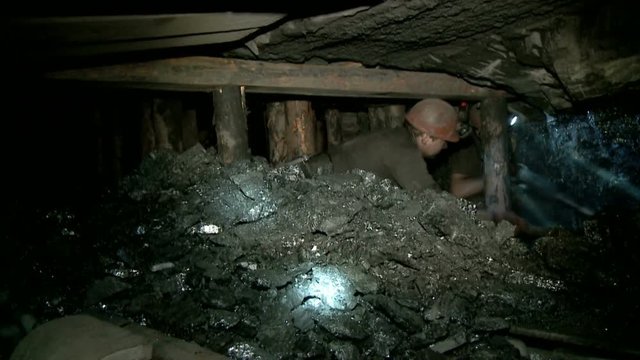 Miner produces coal at depth in the mine using a jackhammer