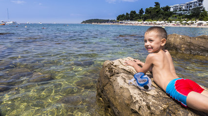 The boy relaxing on the beach.