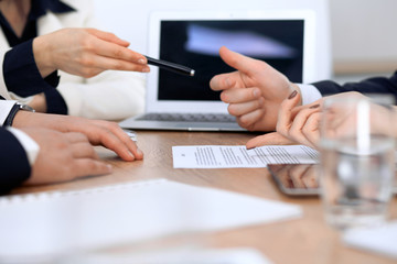 Close up of woman hands giving a pen to businessman for contract signing