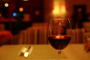 Serving a glass of red wine in a restaurant