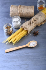 Bunch of spaghetti in sackcloth and string bobbin