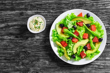  salad of  lettuce, avocado, chunks of salted salmon