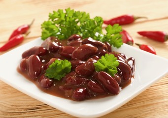 red beans in sauce on a wooden background