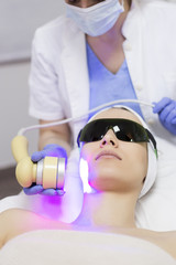 Laser treatment at salon, woman with protective glasses