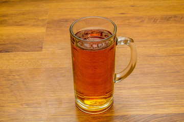 mug of beer on wooden background